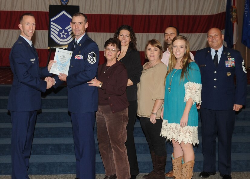 Master Sgt. Roman Vyvial, 2nd Aerospace Medicine Squadron, receives a certificate of promotion from Col. Leland Bohannon, 2nd Bomb Wing vice commander, and Chief Master Sgt. Stephen Lebrun, 2nd Operations Group, during the January Wing Promotion Ceremony on Barksdale Air Force Base, La., Jan. 31, 2014. (U.S. Air Force photo)