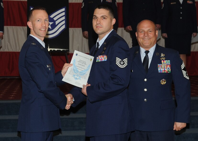 Tech. Sgt. James Henry, 26th Operational Weather Squadron, receives a certificate of promotion from Col. Leland Bohannon, 2nd Bomb Wing vice commander, and Chief Master Sgt. Stephen Lebrun, 2nd Operations Group, during the January Wing Promotion Ceremony on Barksdale Air Force Base, La., Jan. 31, 2014. (U.S. Air Force photo)