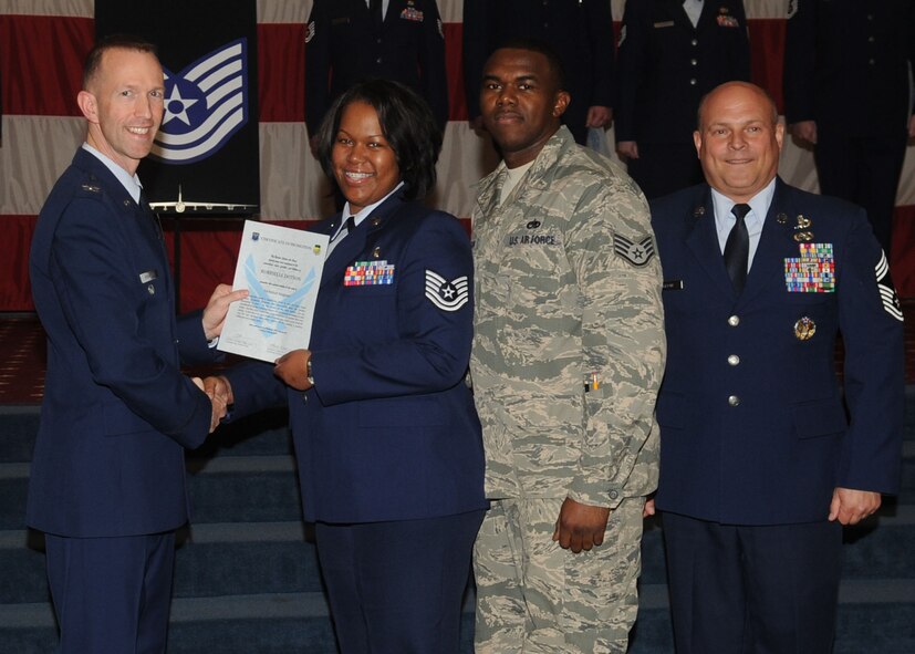 Tech. Sgt. Robrielle Dotson, 2nd Medical Operations Squadron, receives a certificate of promotion from Col. Leland Bohannon, 2nd Bomb Wing vice commander, and Chief Master Sgt. Stephen Lebrun, 2nd Operations Group, during the January Wing Promotion Ceremony on Barksdale Air Force Base, La., Jan. 31, 2014. (U.S. Air Force photo)