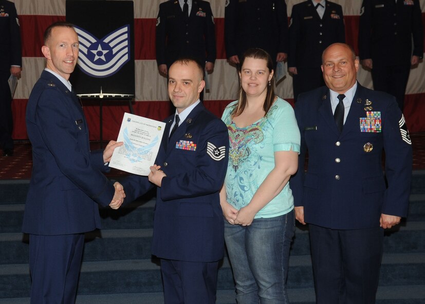 Tech. Sgt. Brandon Rollins, 2nd Maintenance Squadron, receives a certificate of promotion from Col. Leland Bohannon, 2nd Bomb Wing vice commander, and Chief Master Sgt. Stephen Lebrun, 2nd Operations Group, during the January Wing Promotion Ceremony on Barksdale Air Force Base, La., Jan. 31, 2014. (U.S. Air Force photo)