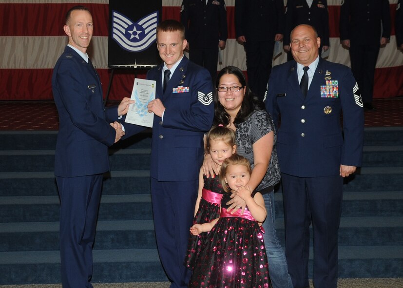 Tech. Sgt. Eric McKenzie, 2nd Maintenance Squadron, receives a certificate of promotion from Col. Leland Bohannon, 2nd Bomb Wing vice commander, and Chief Master Sgt. Stephen Lebrun, 2nd Operations Group, during the January Wing Promotion Ceremony on Barksdale Air Force Base, La., Jan. 31, 2014. (U.S. Air Force photo)