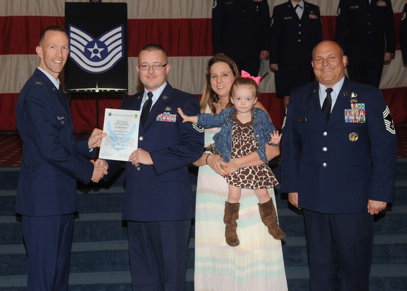 Tech. Sgt. Eric McKenzie, 2nd Maintenance Squadron, receives a certificate of promotion from Col. Leland Bohannon, 2nd Bomb Wing vice commander, and Chief Master Sgt. Stephen Lebrun, 2nd Operations Group, during the January Wing Promotion Ceremony on Barksdale Air Force Base, La., Jan. 31, 2014. (U.S. Air Force photo)