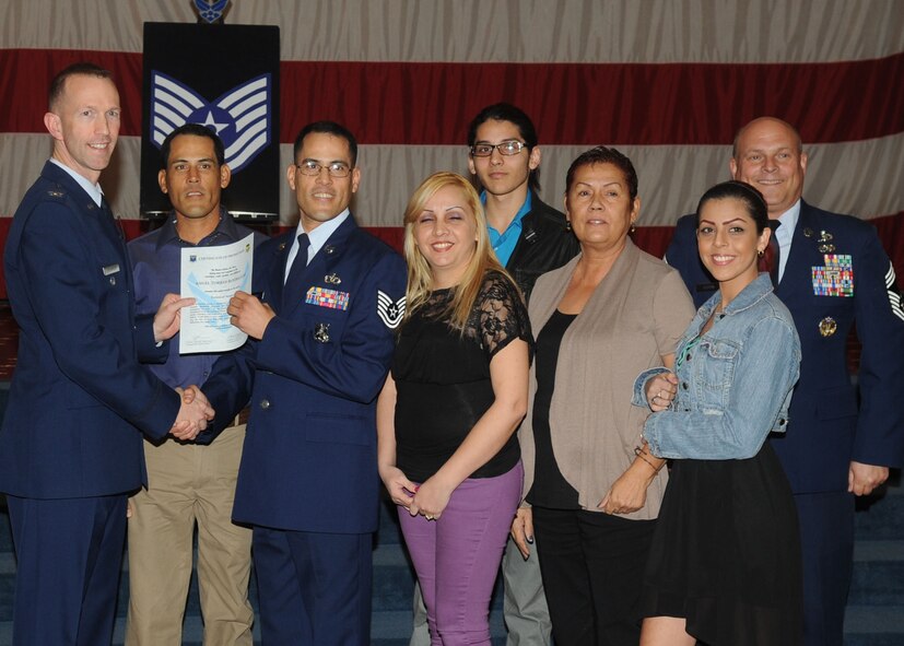 Tech. Sgt. Angel Torres Rodriguez, 2nd Civil Engineer Squadron, receives a certificate of promotion from Col. Leland Bohannon, 2nd Bomb Wing vice commander, and Chief Master Sgt. Stephen Lebrun, 2nd Operations Group, during the January Wing Promotion Ceremony on Barksdale Air Force Base, La., Jan. 31, 2014. (U.S. Air Force photo)