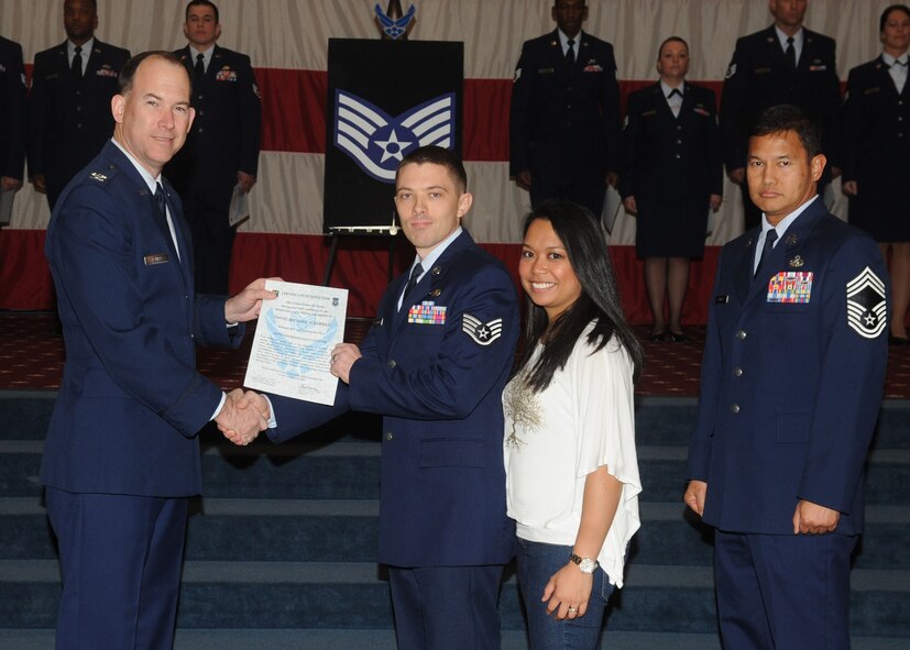 Staff Sgt. David Ackerman, 608th Air and Space Operations Center, receives a certificate of promotion from Col. Russell Mathers, 8th Air Force chief of staff, during the January Wing Promotion Ceremony on Barksdale Air Force Base, La., Jan. 31, 2014. (U.S. Air Force photo)