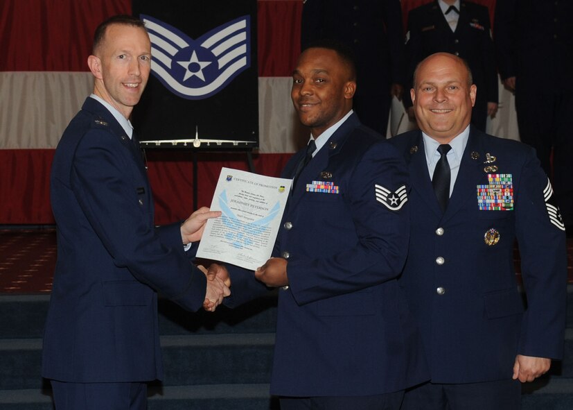 Staff Sgt. Jerahmey Peterson, 2nd Maintenance Squadron, receives a certificate of promotion from Col. Leland Bohannon, 2nd Bomb Wing vice commander, and Chief Master Sgt. Stephen Lebrun, 2nd Operations Group, during the January Wing Promotion Ceremony on Barksdale Air Force Base, La., Jan. 31, 2014. (U.S. Air Force photo)