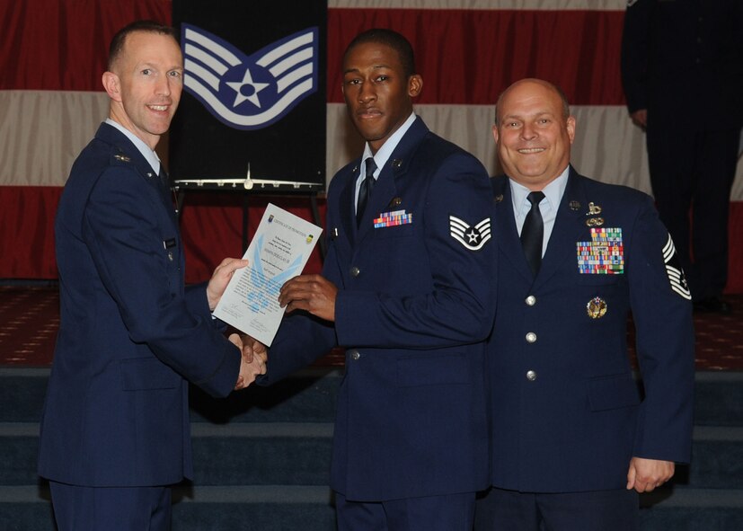 Staff Sgt. Shawn Douglas, 2nd Maintenance Squadron, receives a certificate of promotion from Col. Leland Bohannon, 2nd Bomb Wing vice commander, and Chief Master Sgt. Stephen Lebrun, 2nd Operations Group, during the January Wing Promotion Ceremony on Barksdale Air Force Base, La., Jan. 31, 2014. (U.S. Air Force photo)