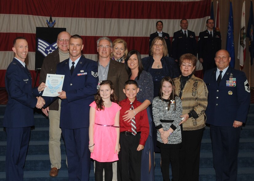 Staff Sgt. Michael Baker, 2nd Logistics Readiness Squadron, receives a certificate of promotion from Col. Leland Bohannon, 2nd Bomb Wing vice commander, and Chief Master Sgt. Stephen Lebrun, 2nd Operations Group, during the January Wing Promotion Ceremony on Barksdale Air Force Base, La., Jan. 31, 2014. (U.S. Air Force photo)