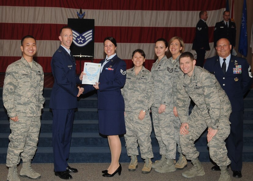 Staff Sgt. Shannon Kealoha, 2nd Bomb Wing, receives a certificate of promotion from Col. Leland Bohannon, 2nd BW vice commander, and Chief Master Sgt. Stephen Lebrun, 2nd Operations Group, during the January Wing Promotion Ceremony on Barksdale Air Force Base, La., Jan. 31, 2014. (U.S. Air Force photo)