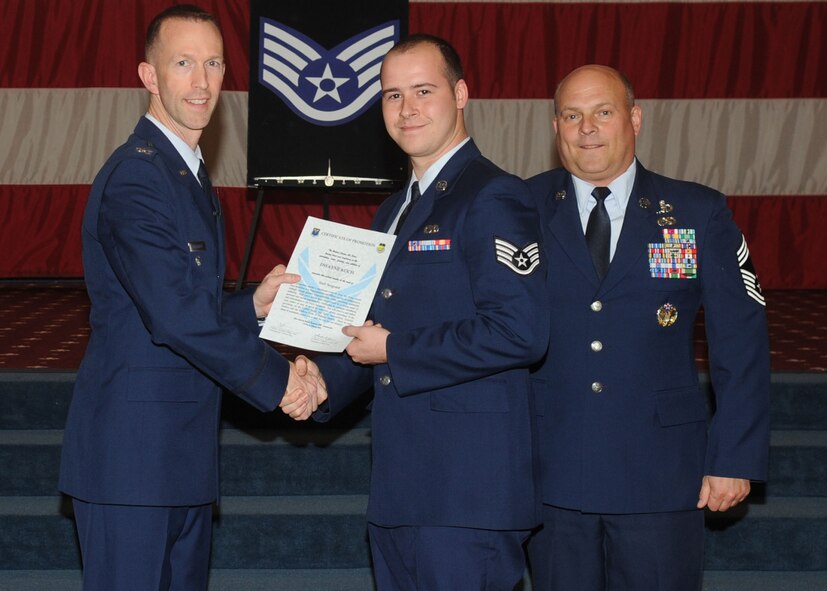 Staff Sgt. Dwayne Koch, 2nd Aircraft Maintenance Squadron, receives a certificate of promotion from Col. Leland Bohannon, 2nd Bomb Wing vice commander, and Chief Master Sgt. Stephen Lebrun, 2nd Operations Group, during the January Wing Promotion Ceremony on Barksdale Air Force Base, La., Jan. 31, 2014. (U.S. Air Force photo)