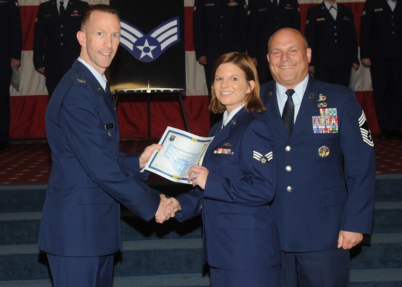 Senior Airman Sarah Thorn, 26th Operational Weather Squadron, receives a certificate of promotion from Col. Leland Bohannon, 2nd Bomb Wing vice commander, and Chief Master Sgt. Stephen Lebrun, 2nd Operations Group, during the January Wing Promotion Ceremony on Barksdale Air Force Base, La., Jan. 31, 2014. (U.S. Air Force photo)