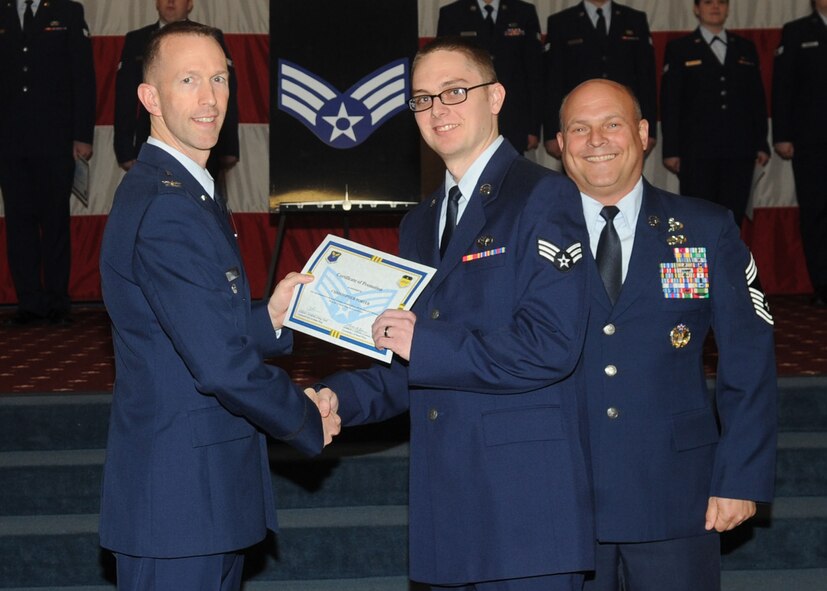 Senior Airman Christopher Porter, 2nd Operations Support Squadron, receives a certificate of promotion from Col. Leland Bohannon, 2nd Bomb Wing vice commander, and Chief Master Sgt. Stephen Lebrun, 2nd Operations Group, during the January Wing Promotion Ceremony on Barksdale Air Force Base, La., Jan. 31, 2014. (U.S. Air Force photo)