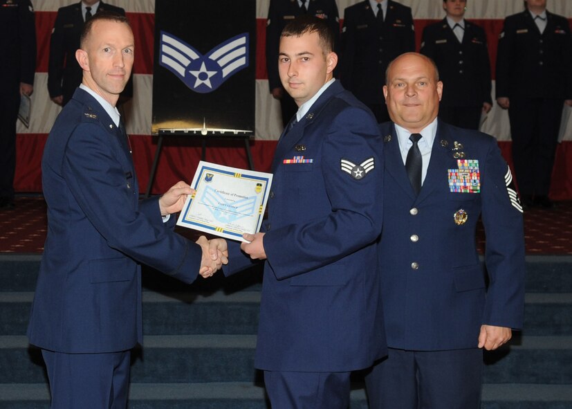 Senior Airman Casey Glosup, 2nd Munitions Squadron, receives a certificate of promotion from Col. Leland Bohannon, 2nd Bomb Wing vice commander, and Chief Master Sgt. Stephen Lebrun, 2nd Operations Group, during the January Wing Promotion Ceremony on Barksdale Air Force Base, La., Jan. 31, 2014. (U.S. Air Force photo)