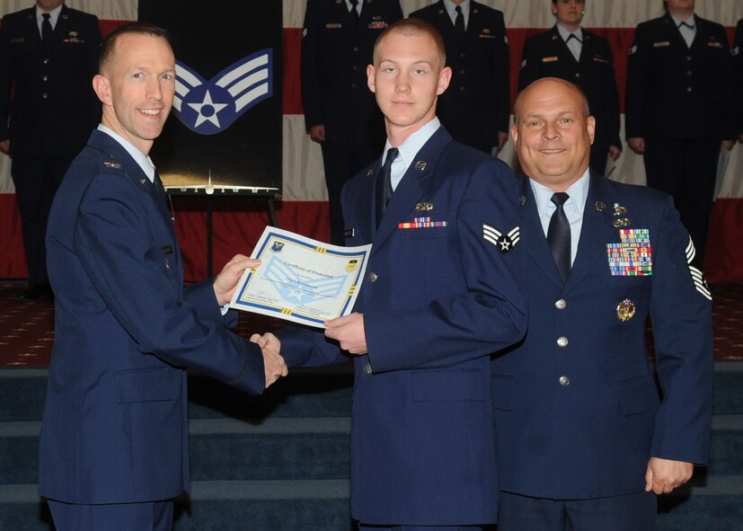 Senior Airman Cody Randolph, 2nd Maintenance Squadron, receives a certificate of promotion from Col. Leland Bohannon, 2nd Bomb Wing vice commander, and Chief Master Sgt. Stephen Lebrun, 2nd Operations Group, during the January Wing Promotion Ceremony on Barksdale Air Force Base, La., Jan. 31, 2014. (U.S. Air Force photo)
