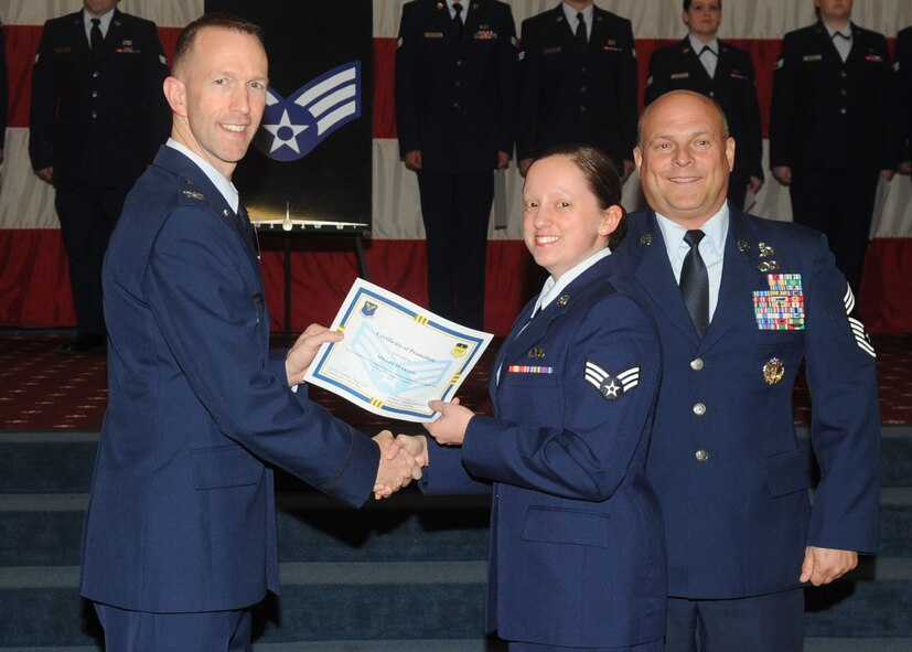Senior Airman Shelby Pearson, 2nd Maintenance Squadron, receives a certificate of promotion from Col. Leland Bohannon, 2nd Bomb Wing vice commander, and Chief Master Sgt. Stephen Lebrun, 2nd Operations Group, during the January Wing Promotion Ceremony on Barksdale Air Force Base, La., Jan. 31, 2014. (U.S. Air Force photo)