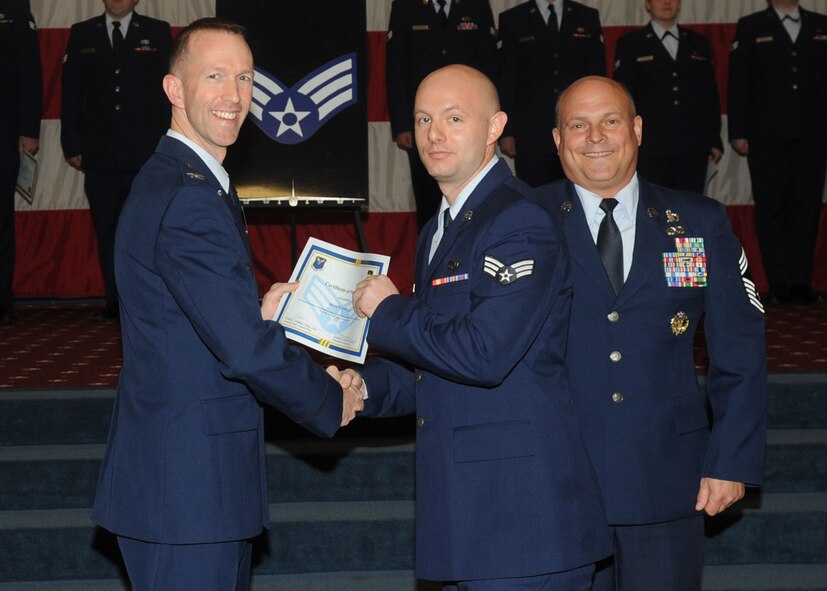 Senior Airman Shaun Oneal, 2nd Maintenance Squadron, receives a certificate of promotion from Col. Leland Bohannon, 2nd Bomb Wing vice commander, and Chief Master Sgt. Stephen Lebrun, 2nd Operations Group, during the January Wing Promotion Ceremony on Barksdale Air Force Base, La., Jan. 31, 2014. (U.S. Air Force photo)