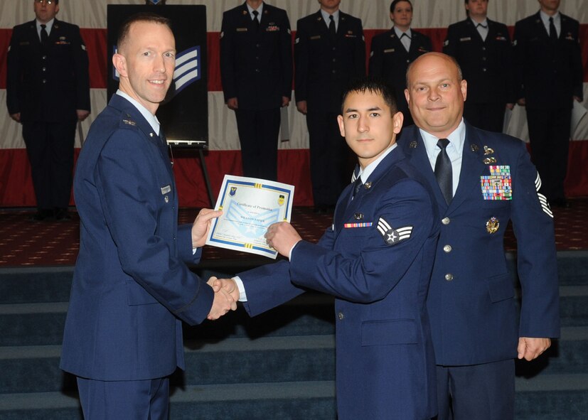 Senior Airman William Mapier, 2nd Maintenance Squadron, receives a certificate of promotion from Col. Leland Bohannon, 2nd Bomb Wing vice commander, and Chief Master Sgt. Stephen Lebrun, 2nd Operations Group, during the January Wing Promotion Ceremony on Barksdale Air Force Base, La., Jan. 31, 2014. (U.S. Air Force photo)