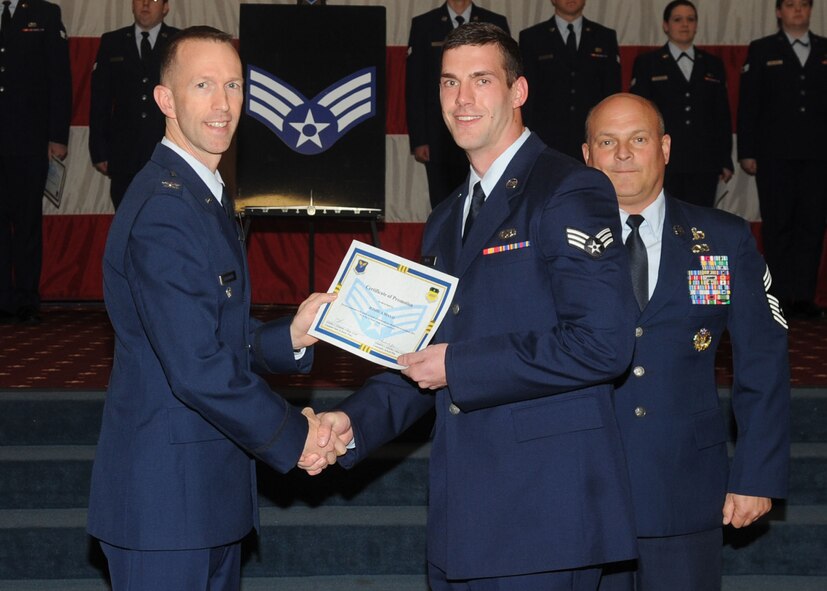 Senior Airman Joshua Mayo, 2nd Maintenance Squadron, receives a certificate of promotion from Col. Leland Bohannon, 2nd Bomb Wing vice commander, and Chief Master Sgt. Stephen Lebrun, 2nd Operations Group, during the January Wing Promotion Ceremony on Barksdale Air Force Base, La., Jan. 31, 2014. (U.S. Air Force photo)