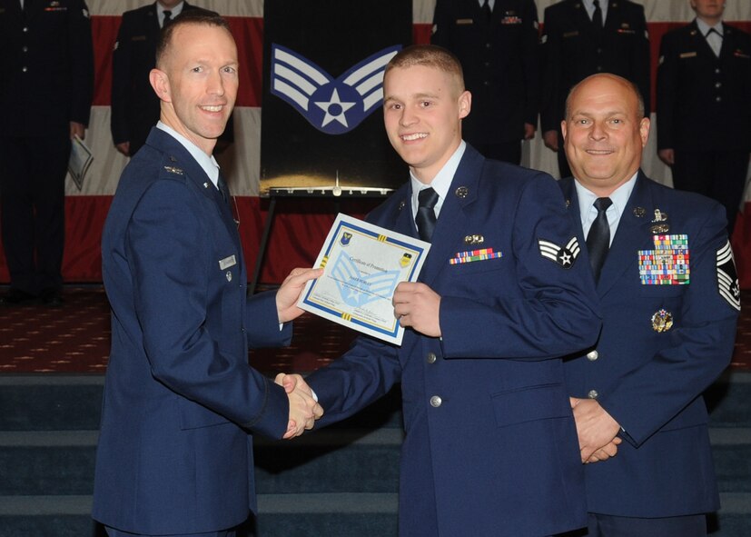 Senior Airman Jakeb Hurley, 2nd Maintenance Squadron, receives a certificate of promotion from Col. Leland Bohannon, 2nd Bomb Wing vice commander, and Chief Master Sgt. Stephen Lebrun, 2nd Operations Group, during the January Wing Promotion Ceremony on Barksdale Air Force Base, La., Jan. 31, 2014. (U.S. Air Force photo)