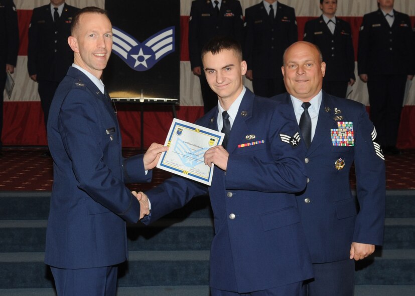 Senior Airman Zachary Dutton, 2nd Maintenance Squadron, receives a certificate of promotion from Col. Leland Bohannon, 2nd Bomb Wing vice commander, and Chief Master Sgt. Stephen Lebrun, 2nd Operations Group, during the January Wing Promotion Ceremony on Barksdale Air Force Base, La., Jan. 31, 2014. (U.S. Air Force photo)