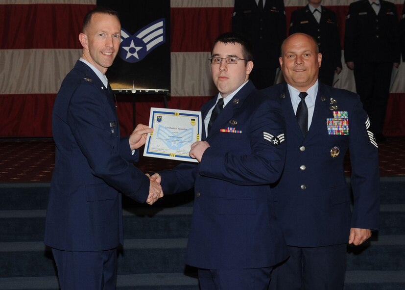Senior Airman Andrew Boyer, 2nd Maintenance Squadron, receives a certificate of promotion from Col. Leland Bohannon, 2nd Bomb Wing vice commander, and Chief Master Sgt. Stephen Lebrun, 2nd Operations Group, during the January Wing Promotion Ceremony on Barksdale Air Force Base, La., Jan. 31, 2014. (U.S. Air Force photo)