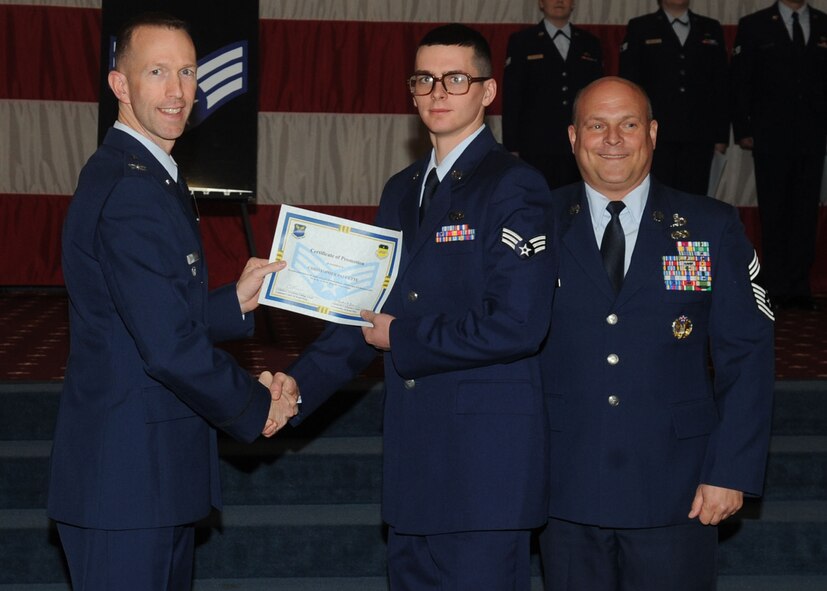 Senior Airman Christopher Faucette, 2nd Logistics Readiness Squadron, receives a certificate of promotion from Col. Leland Bohannon, 2nd Bomb Wing vice commander, and Chief Master Sgt. Stephen Lebrun, 2nd Operations Group, during the January Wing Promotion Ceremony on Barksdale Air Force Base, La., Jan. 31, 2014. (U.S. Air Force photo)