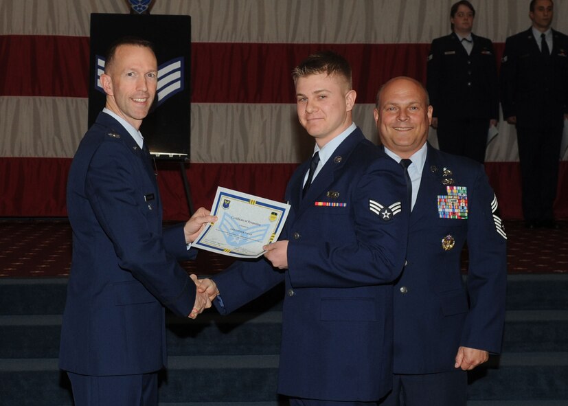 Senior Airman Kristopher Tolar, 2nd Contracting Squadron, receives a certificate of promotion from Col. Leland Bohannon, 2nd Bomb Wing vice commander, and Chief Master Sgt. Stephen Lebrun, 2nd Operations Group, during the January Wing Promotion Ceremony on Barksdale Air Force Base, La., Jan. 31, 2014. (U.S. Air Force photo)