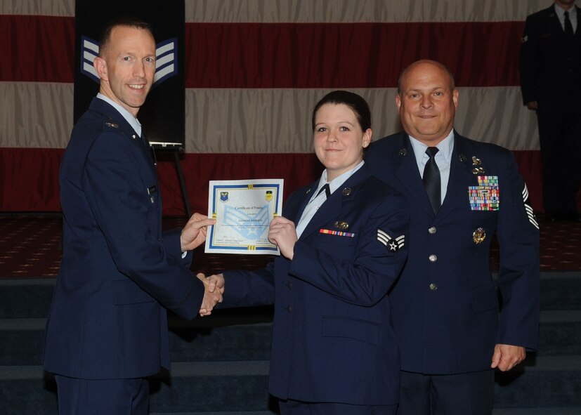 Senior Airman Jasmine Rieberger, 2nd Contracting Squadron, receives a certificate of promotion from Col. Leland Bohannon, 2nd Bomb Wing vice commander, and Chief Master Sgt. Stephen Lebrun, 2nd Operations Group, during the January Wing Promotion Ceremony on Barksdale Air Force Base, La., Jan. 31, 2014. (U.S. Air Force photo)