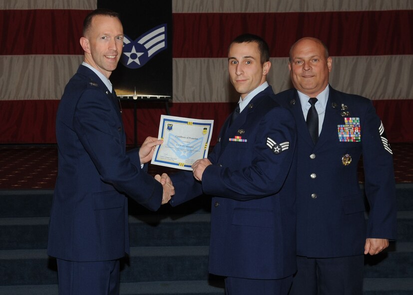 Senior Airman Zachary Sheridan, 2nd Communications Squadron, receives a certificate of promotion from Col. Leland Bohannon, 2nd Bomb Wing vice commander, and Chief Master Sgt. Stephen Lebrun, 2nd Operations Group, during the January Wing Promotion Ceremony on Barksdale Air Force Base, La., Jan. 31, 2014. (U.S. Air Force photo)