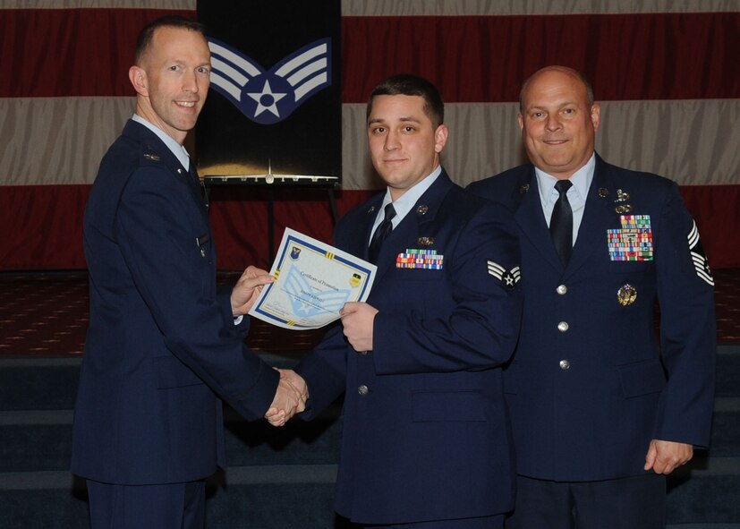Senior Airman Joseph Kidwell, 2nd Communications Squadron, receives a certificate of promotion from Col. Leland Bohannon, 2nd Bomb Wing vice commander, and Chief Master Sgt. Stephen Lebrun, 2nd Operations Group, during the January Wing Promotion Ceremony on Barksdale Air Force Base, La., Jan. 31, 2014. (U.S. Air Force photo)