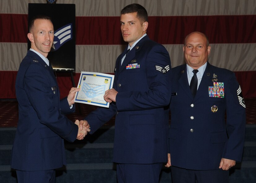 Senior Airman Benjamin Deachin, 2nd Aircraft Maintenance Squadron, receives a certificate of promotion from Col. Leland Bohannon, 2nd Bomb Wing vice commander, and Chief Master Sgt. Stephen Lebrun, 2nd Operations Group, during the January Wing Promotion Ceremony on Barksdale Air Force Base, La., Jan. 31, 2014. (U.S. Air Force photo)