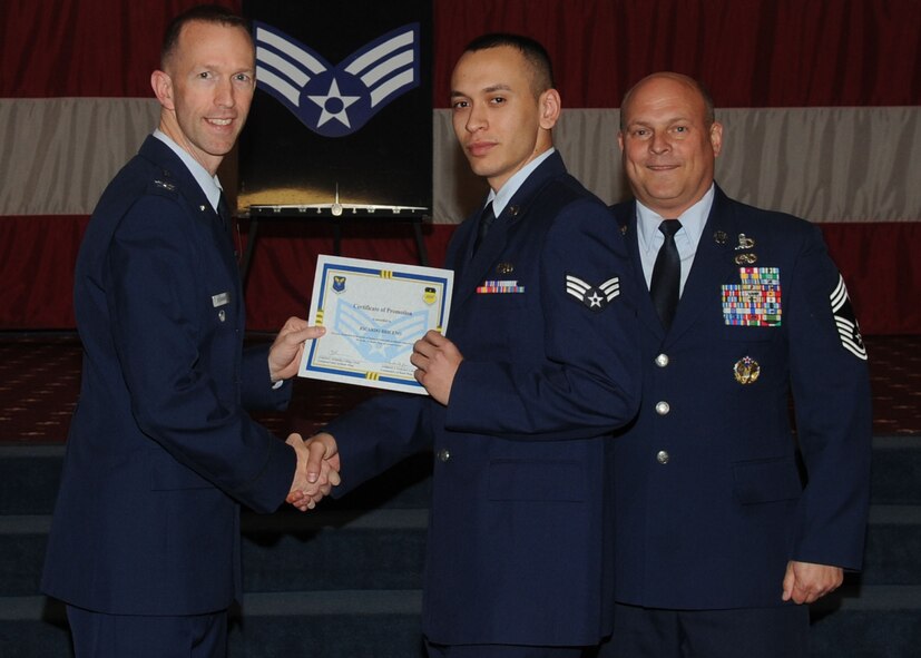 Senior Airman Ricardo Briceno, 2nd Aircraft Maintenance Squadron, receives a certificate of promotion from Col. Leland Bohannon, 2nd Bomb Wing vice commander, and Chief Master Sgt. Stephen Lebrun, 2nd Operations Group, during the January Wing Promotion Ceremony on Barksdale Air Force Base, La., Jan. 31, 2014. (U.S. Air Force photo)
