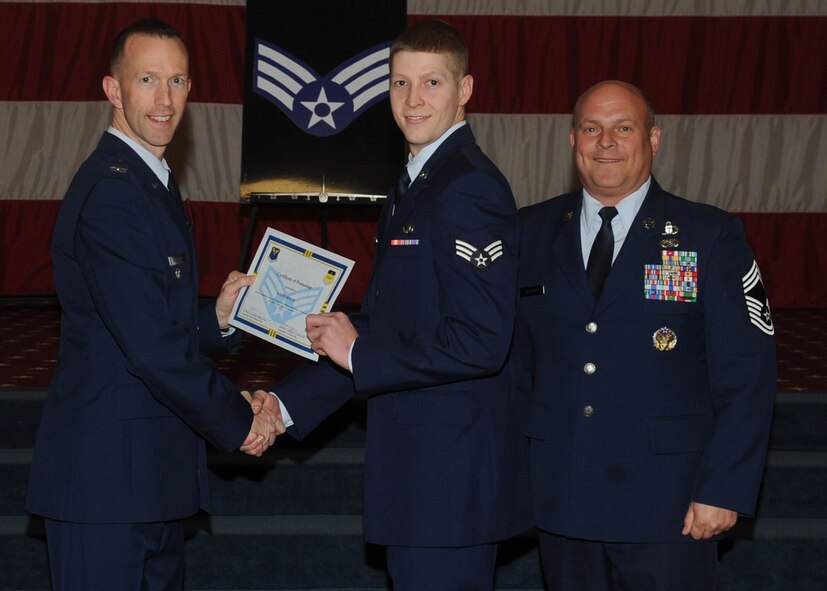 Senior Airman Justin Boone, 2nd Aircraft Maintenance Squadron, receives a certificate of promotion from Col. Leland Bohannon, 2nd Bomb Wing vice commander, and Chief Master Sgt. Stephen Lebrun, 2nd Operations Group, during the January Wing Promotion Ceremony on Barksdale Air Force Base, La., Jan. 31, 2014. (U.S. Air Force photo)