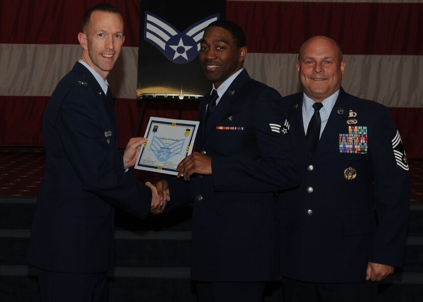 Senior Airman Adrian Green, 2nd Aerospace Medicine Squadron, receives a certificate of promotion from Col. Leland Bohannon, 2nd Bomb Wing vice commander, and Chief Master Sgt. Stephen Lebrun, 2nd Operations Group, during the January Wing Promotion Ceremony on Barksdale Air Force Base, La., Jan. 31, 2014. (U.S. Air Force photo)