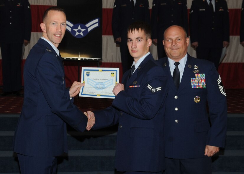 Airman 1st Class Kyle Meyers, 2nd Maintenance Squadron, receives a certificate of promotion from Col. Leland Bohannon, 2nd Bomb Wing vice commander, and Chief Master Sgt. Stephen Lebrun, 2nd Operations Group, during the January Wing Promotion Ceremony on Barksdale Air Force Base, La., Jan. 31, 2014. (U.S. Air Force photo)