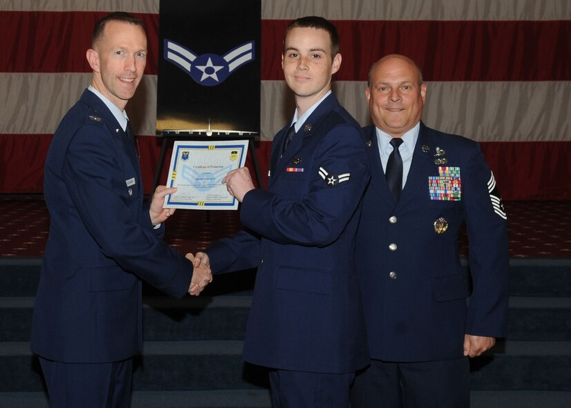 Airman 1st Class Frank Muller, 2nd Aircraft Maintenance Squadron, receives a certificate of promotion from Col. Leland Bohannon, 2nd Bomb Wing vice commander, and Chief Master Sgt. Stephen Lebrun, 2nd Operations Group, during the January Wing Promotion Ceremony on Barksdale Air Force Base, La., Jan. 31, 2014. (U.S. Air Force photo)