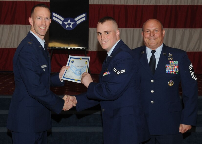 Airman 1st Class Andrew Hodges, 2nd Aircraft Maintenance Squadron, receives a certificate of promotion from Col. Leland Bohannon, 2nd Bomb Wing vice commander, and Chief Master Sgt. Stephen Lebrun, 2nd Operations Group, during the January Wing Promotion Ceremony on Barksdale Air Force Base, La., Jan. 31, 2014. (U.S. Air Force photo)