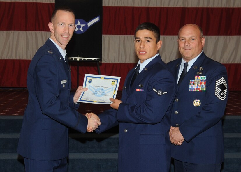 Airman Jesus Izaguirre, 2nd Civil Engineer Squadron, receives a certificate of promotion from Col. Leland Bohannon, 2nd Bomb Wing vice commander, and Chief Master Sgt. Stephen Lebrun, 2nd Operations Group, during the January Wing Promotion Ceremony on Barksdale Air Force Base, La., Jan. 31, 2014. (U.S. Air Force photo)