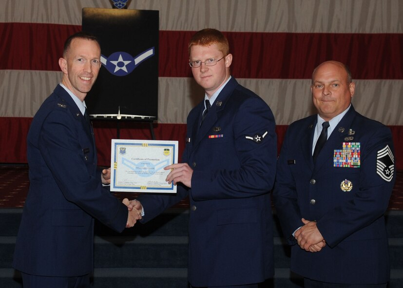 Airman William Luster, 2nd Aircraft Maintenance Squadron, receives a certificate of promotion from Col. Leland Bohannon, 2nd Bomb Wing vice commander, and Chief Master Sgt. Stephen Lebrun, 2nd Operations Group, during the January Wing Promotion Ceremony on Barksdale Air Force Base, La., Jan. 31, 2014. (U.S. Air Force photo)