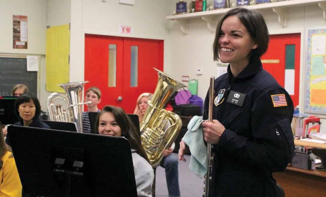 Senior Airman Jennifer L. Nelson gives advice to Holli Araiza and the Cimarron High School Band during a clinic before Rampart Winds’ performance.  

Photo by: Gabriel Weinstein