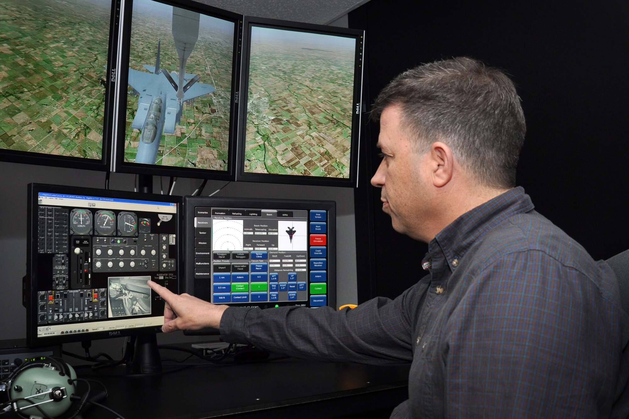 Mark Moore, BOWST contracting representive, discusses the new boom simulator trainer from the instructor's seat, March 2014. (U.S. Air Force photo by Staff Sgt. Alan Abernethy, 916th ARW/PA)