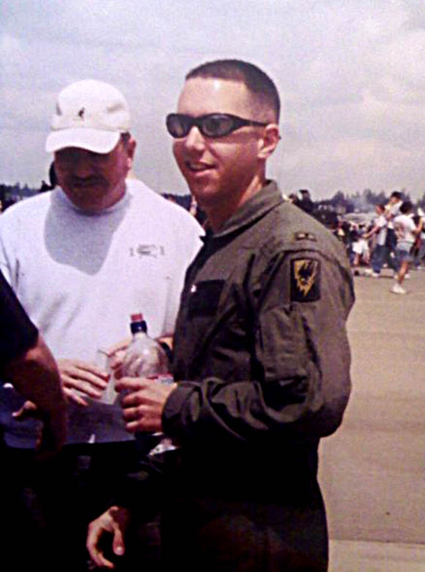 Capt. Colby Harrell, 97th Airlift Squadron pilot, represents the Washington National Guard and its helicopter static at a past McChord Air Force Base, Wash., air show.  Harrell's father, left, a retired Army master sergeant, attended the show. (Courtesy photo)