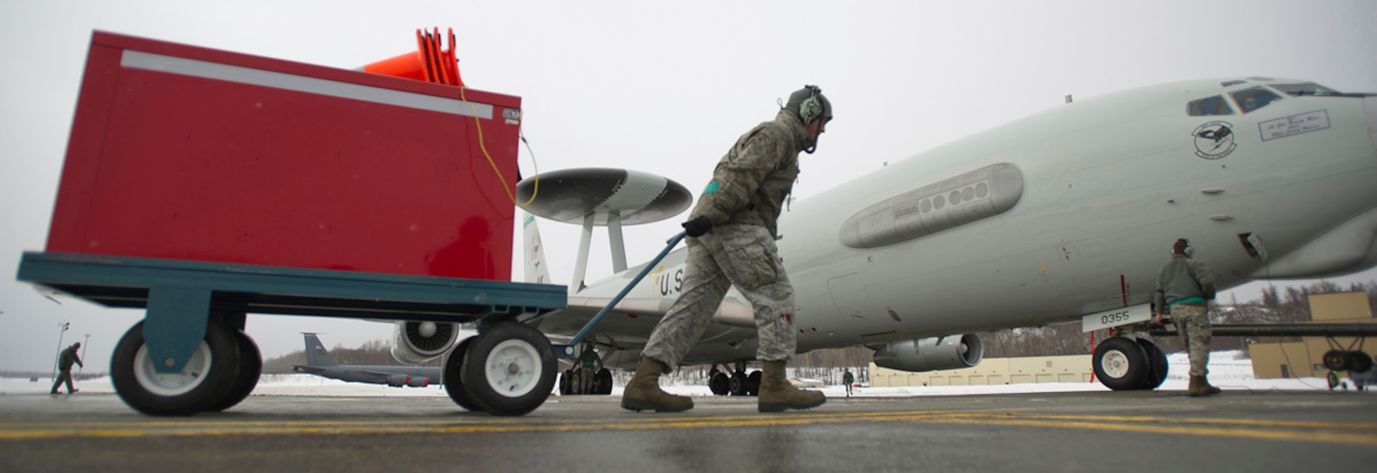 Air Force Staff Sgt. Brian Howard, assigned to the 962nd Aircraft Maintenance Unit, pulls a tool box as he prepares to perform maintenance on a E-3 Sentry Airborne Warning and Control System aircraft after a mission on Joint Base Elmendorf-Richardson, Alaska, Wednesday, March 17, 2014. (U.S. Air Force photo by Justin Connaher/Released)