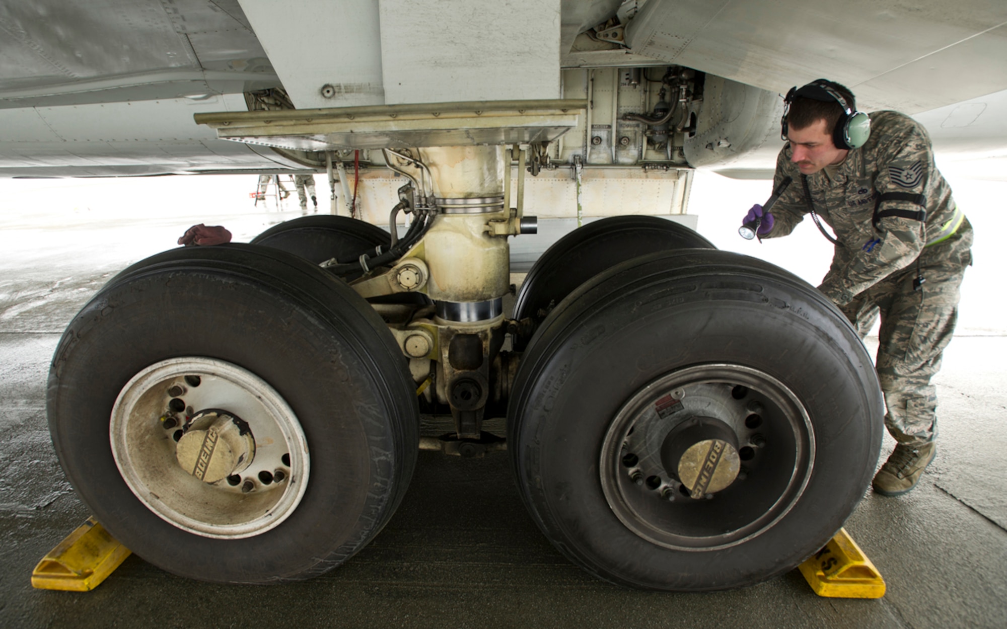 Tech Sgt. Chad McBunch, assigned to the 962nd Aircraft Maintenance Unit, inspects the landing gear on a E-3 Sentry Airborne Warning and Control
System aircraft after a mission on Joint Base Elmendorf-Richardson, Alaska, Wednesday, March 17, 2014. (U.S. Air Force photo by Justin Connaher/Released)