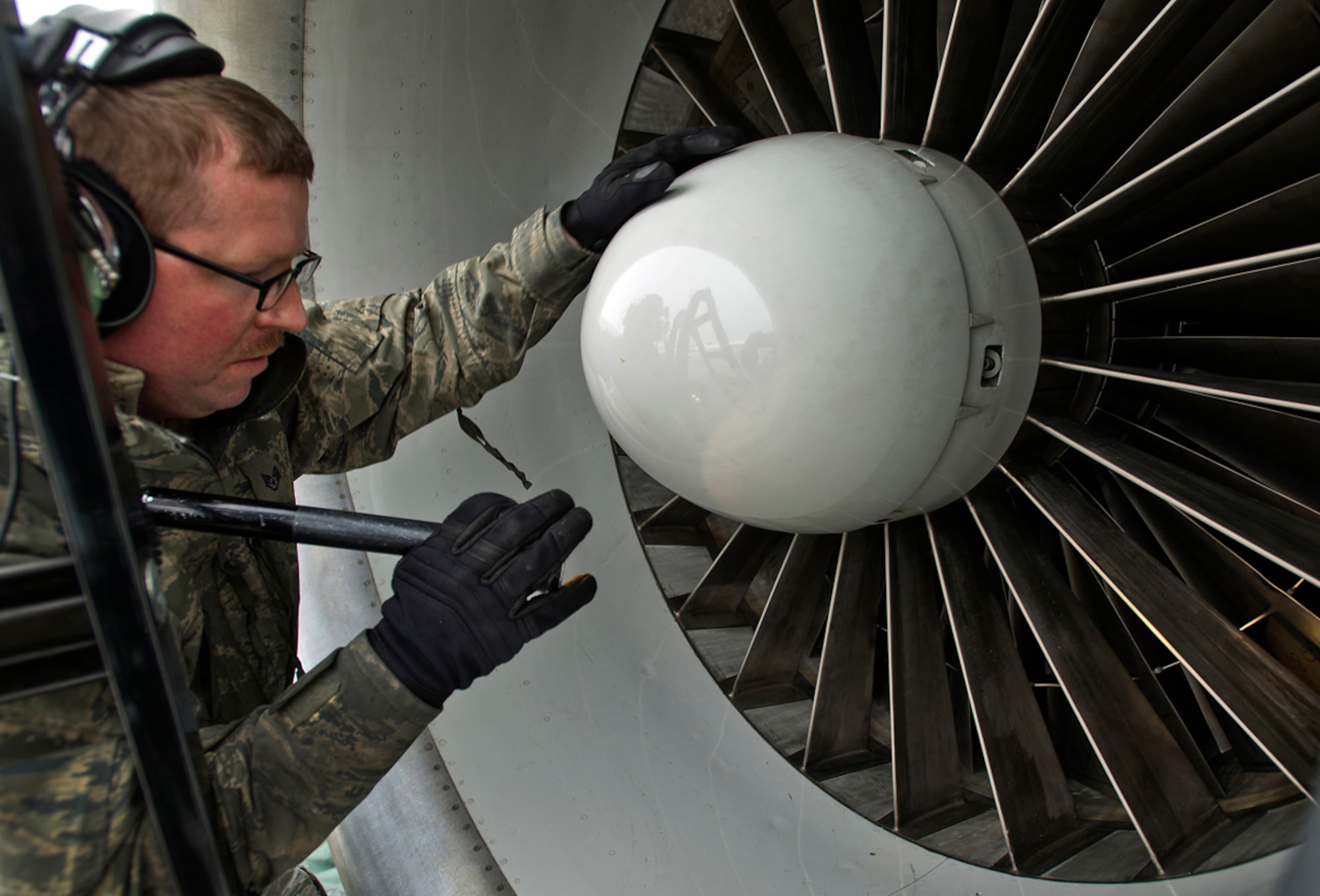 Air Force Staff Sgt. Brian Howard, assigned to the 962nd Aircraft Maintenance Unit, checks an engine on a E-3 Sentry Airborne Warning and Control System aircraft after a mission on Joint Base Elmendorf-Richardson, Alaska, Wednesday, March 17, 2014. (U.S. Air Force photo by Justin Connaher/Released)