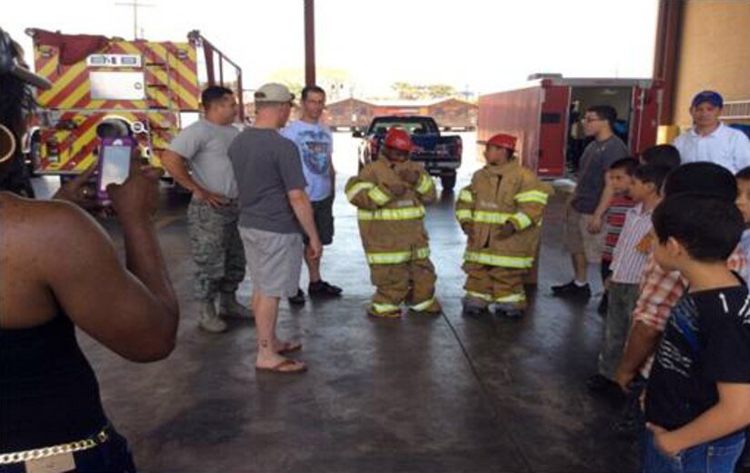 The San Antonio Padua Boys Home enjoyed a day at Soto Cano Air Base, Honduras with the Winged Warriors of the 1-228th Aviation Regiment.  The boys visited the base fire station and learned how to put on the fire protective gear, watched a kids movie and swam at the base pool.  (Courtesy Photo)