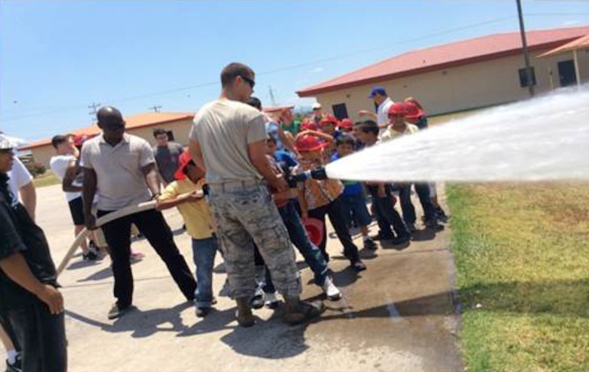 The San Antonio Padua Boys Home enjoyed a day at Soto Cano Air Base, Honduras with the Winged Warriors of the 1-228th Aviation Regiment.  The boys visited the base fire station and learned how to put on the fire protective gear, watched a kids movie and swam at the base pool.  (Courtesy Photo)