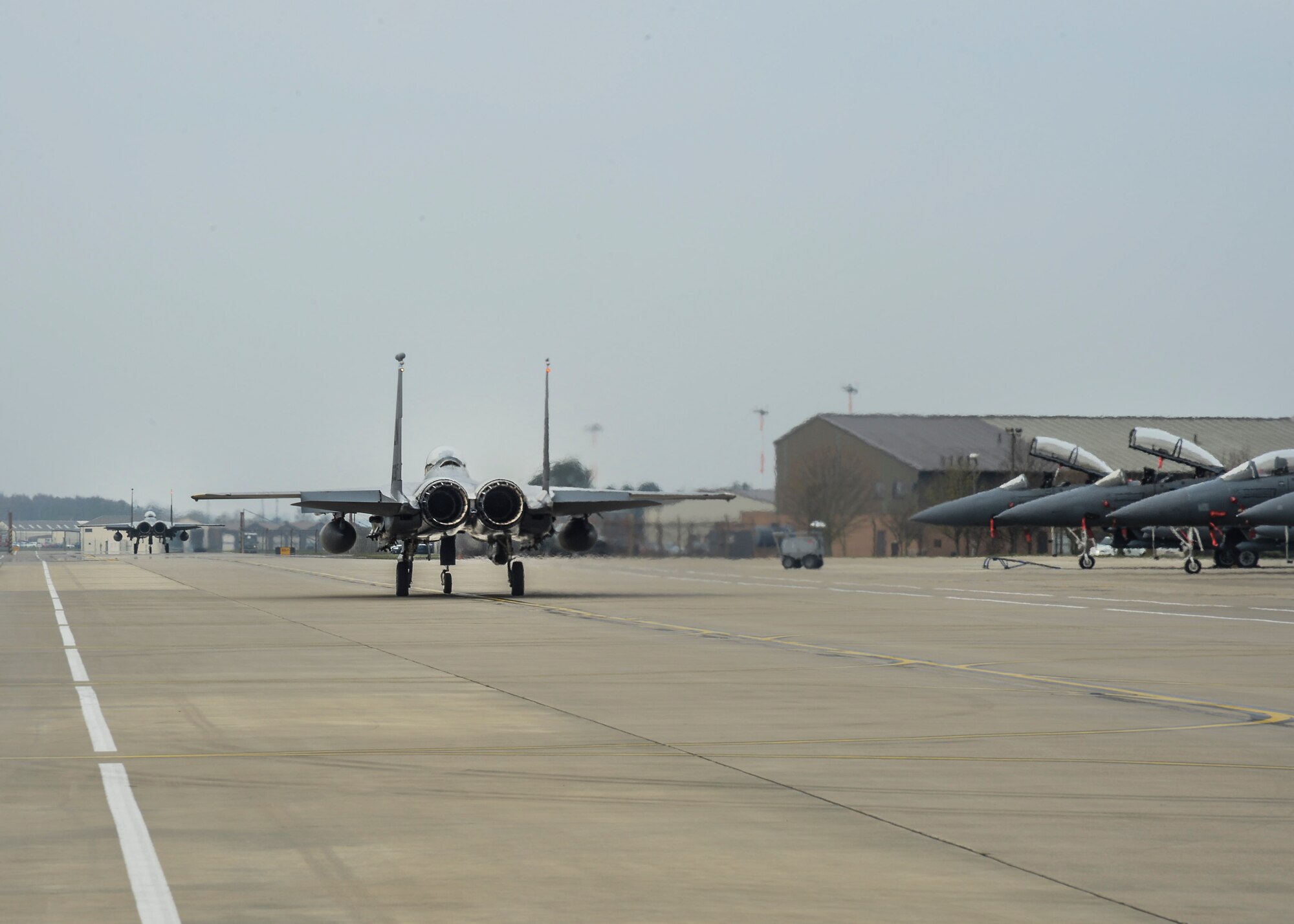 A pair of F-15E Strike Eagles participating in the ExerciseTonnerre Lightning taxi out for takeoff at the flightline on Royal Air Force Lakenheath, England, March, 28, 2014. The 494th FS is participating in Exercise Tonnerre Lightning, which  is a series of training aimed at improving interoperability between the partner-nation air forces of the United Kingdom, France, and the United States. (U.S. Air Force photo by Airman 1st Class Nigel Sandridge/Released)