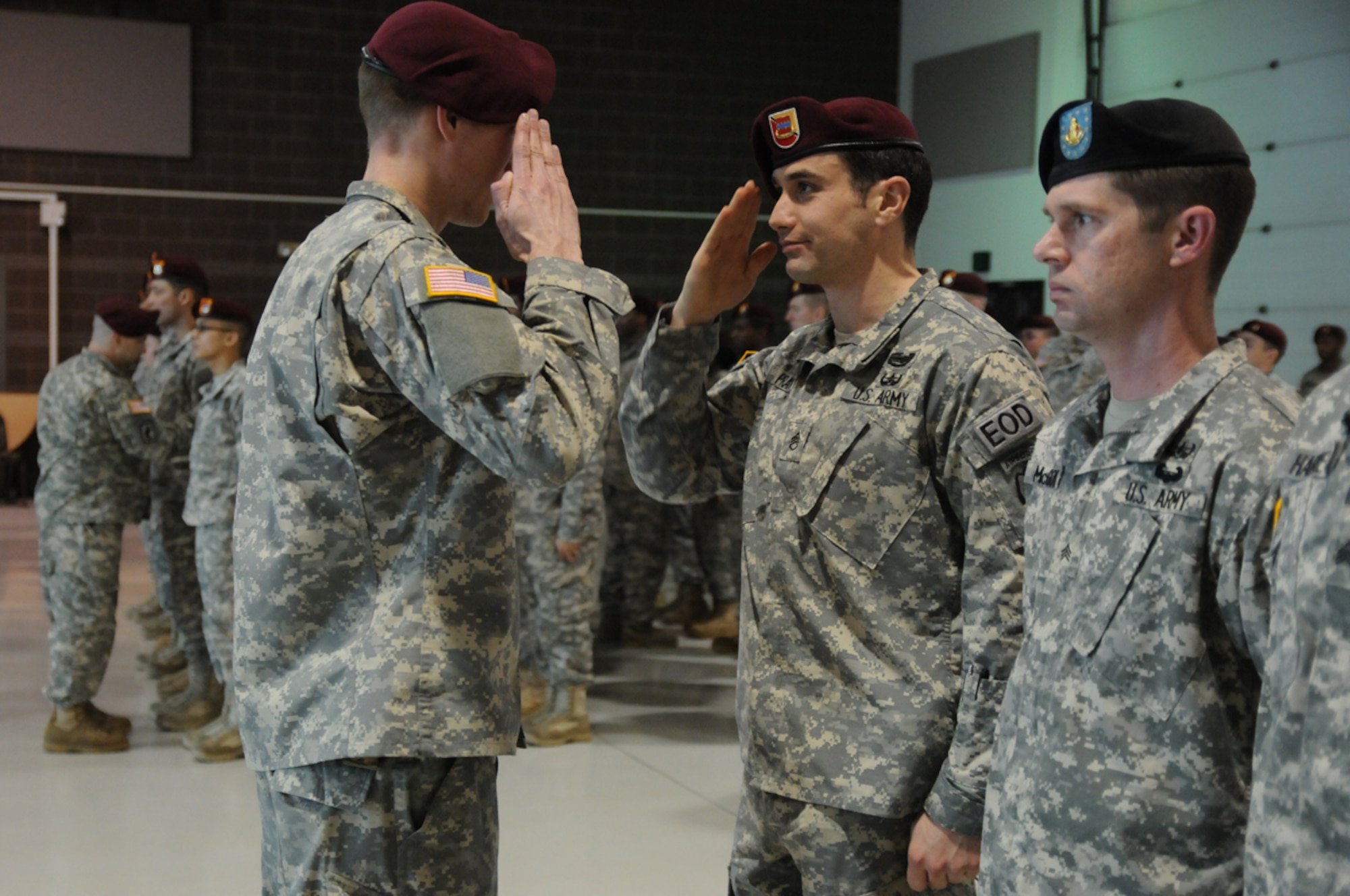 Soldiers of 716th Explosive Ordnance Disposal Company don their new 4th Infantry Brigade Combat Team (Airborne), 25th Infantry Division, shoulder-sleeve insignias during a patch ceremony March 17 at the Alaska National Guard Headquarters. The 716th EOD and the 4th Quartermaster Detachment joined the 725th Brigade Support Battalion. (U.S. Army photo/Staff Sgt. Jeffrey Smith)
