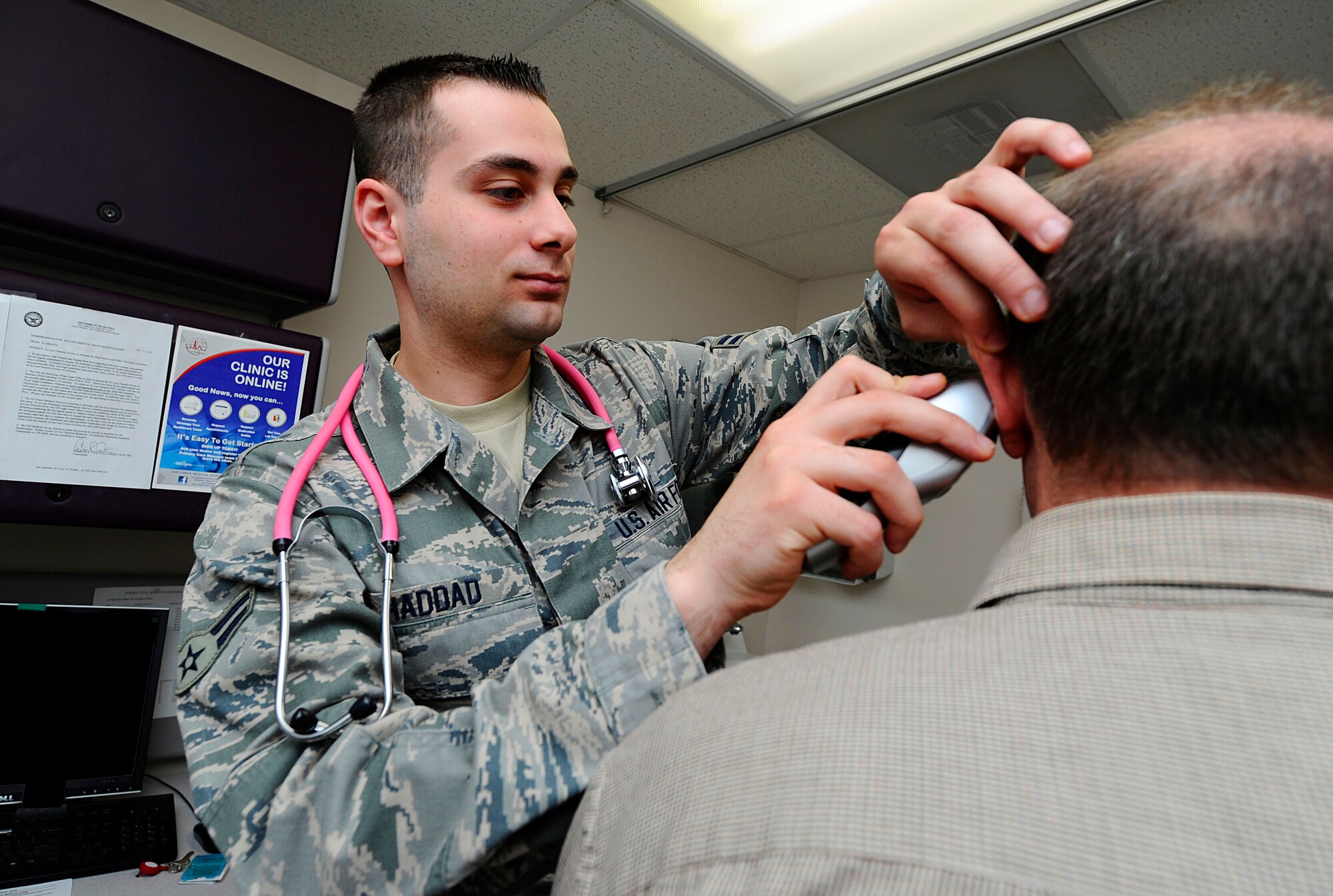 Airman 1st Class Hisham Haddad, 22nd Medical Operations Squadron family health technician, takes a patient’s temperature, March 19, 2014, at McConnell Air Force Base, Kan. Haddad, who spent the first 14 years of his life in Syria, earned his U.S. citizenship in July 2013. (U.S. Air Force photo/Airman 1st Class Victor J. Caputo)