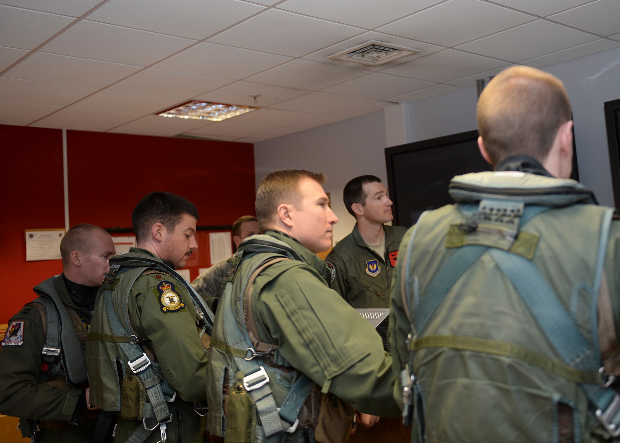 Major Jack Rose, 494th Fighter Squadron chief of planning, briefs pilots participating in exercise Tonnerre Lightning  at the Strike Eagle Complex on Royal Air Force Lakenheath, England, March, 28, 2014. ExerciseTonnerre Lightning  is a series of training aimed at improving interoperability between the partner-nation air forces of the United Kingdom, France, and the United States. (U.S. Air Force photo by Airman 1st Class Nigel Sandridge/Released)
